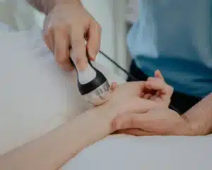 Patient receiving wrist treatment showcasing the benefits of shockwave therapy for tissue healing.